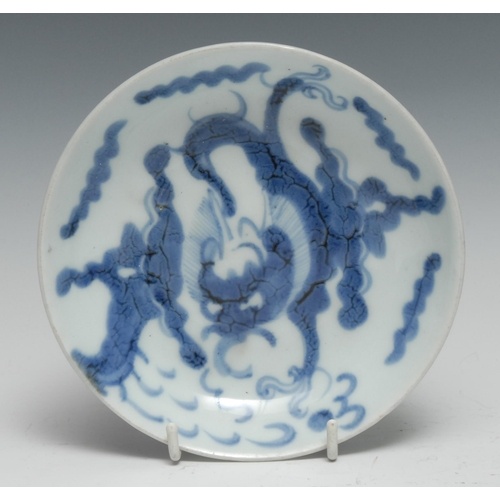 A Chinese circular dish, painted in tones of underglaze blue...