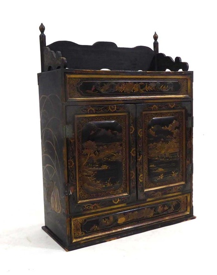 A Chinese lacquered table cabinet, gilt decorated with animals and...