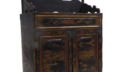 A Chinese lacquered table cabinet, gilt decorated with animals and...