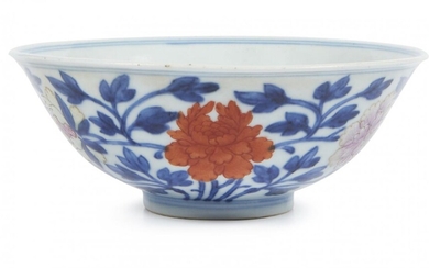 A Chinese porcelain 'peonies' bowl, Qianlong minyao mark and of the period, painted in underglaze blue and famille rose enamels with peonies to the exterior, the flowers picked out in enamels, the leafy stems in underglaze blue, 13cm diameter