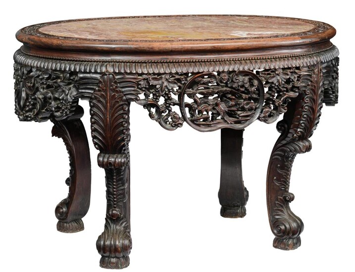 A Chinese richly carved exotic hardwood table with...