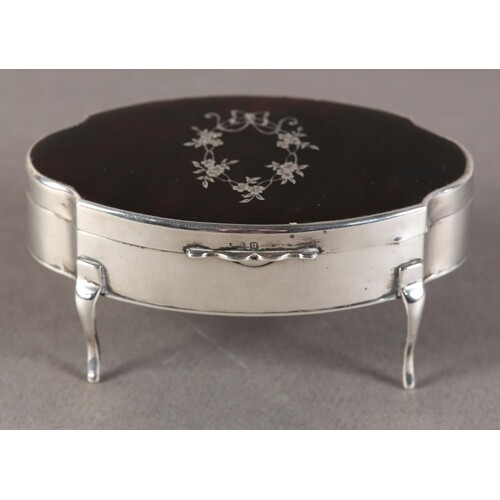 A GEORGE V SILVER DRESSING TABLE BOX OF OVAL FORM, the hinge...