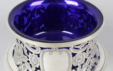 A George V silver dish ring with blue glass liner.