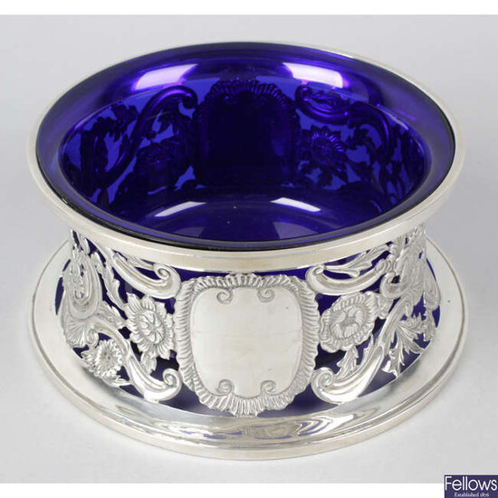 A George V silver dish ring with blue glass liner.