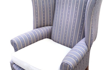 A Georgian style upholstered wing armchair, the arched back above...