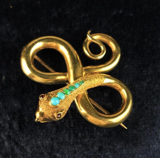 A Gold Snake Brooch inset with small turquoise beads and ruby eyes.