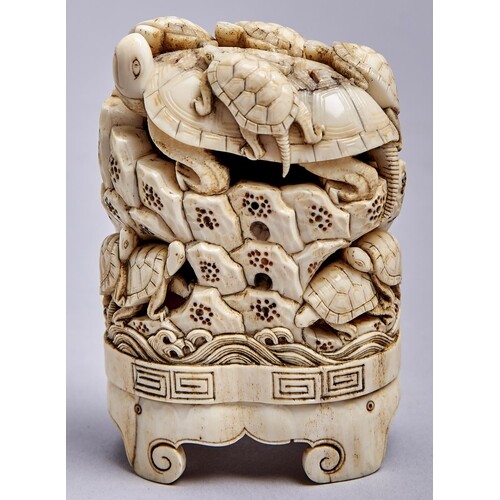 A Japanese ivory okimono, Meiji period, carved with turtles ...