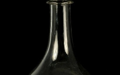 A LARGE GEORGIAN BULBOUS CLEAR GLASS WINE CARAFE with