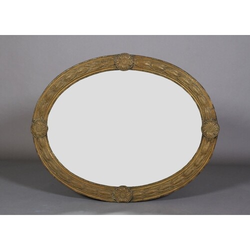 A LATE 19TH CENTURY GILT METAL FRAMED OVAL WALL MIRROR, the ...