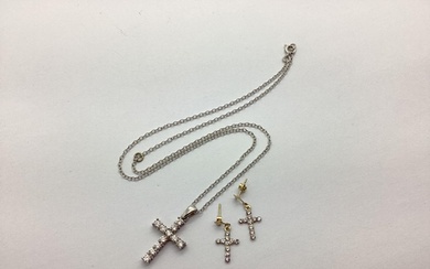 A Modern 9ct White Gold Cross Pendant, claw set, on a 9ct wh...