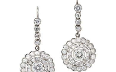 A PAIR OF DIAMOND CLUSTER DROP EARRINGS each comprising a row of round cut diamonds, suspending a