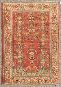 A PERSIAN KASHAN RUG with floral central motifs on a