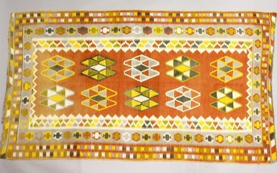 A PERSIAN KELIM CAPET, orange ground with typical