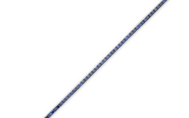 A SAPPHIRE LINE BRACELET in white gold, comprising a row of square step cut sapphires, the sapphi...