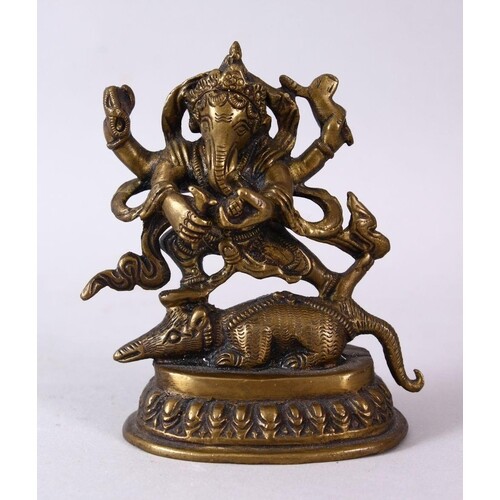 A SMALL INDIAN BRONZE FIGURE OF GANESH UPON BEAST, upon a st...