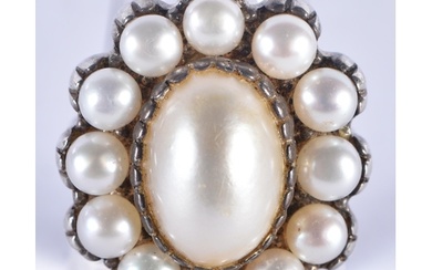 A Silver and Pearl Ring. The central Pearl is surrounded by...