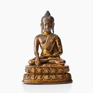 A Tibetan gilt copper alloy figure of Buddha Akshobhya