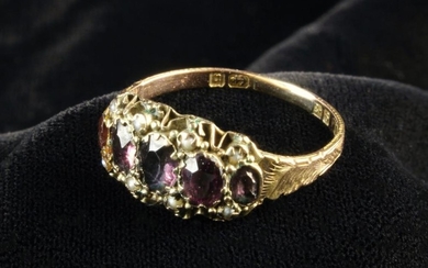 A Victorian Nine Carat Rose Gold Ring Circa 1890, set with five graduated oval cut stones and seed p