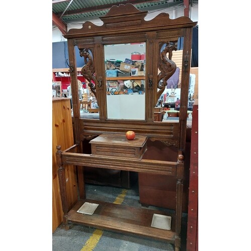 A Victorian dark wood hall rack with bevelled mirror and amp...