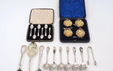 A cased set of four Edwardian silver salts, London, 1902, William Hutton & Sons, each of shell form with gilded interior, complete with four condiment spoons, same date and maker, together with a set of six silver coffee spoons, London, 1939...