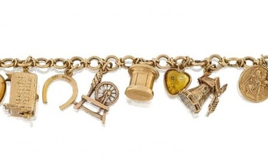 A charm bracelet, the fancy link chain suspending thirteen 9ct gold charms and a single heart shaped polished citrine, charms include: a chest; a windmill; a post box; a spinning wheel; a rotisserie; and a rocking horse, gross weight 43.9g