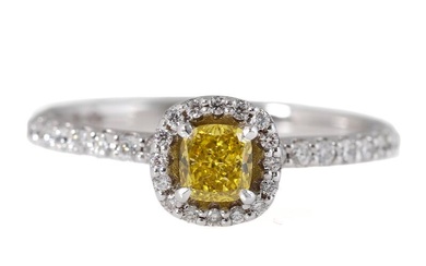 A diamond ring set with Fancy Vivid Yellow cushion-cut diamond weighing app....
