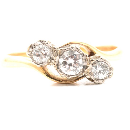 A diamond three stone crossover ring.