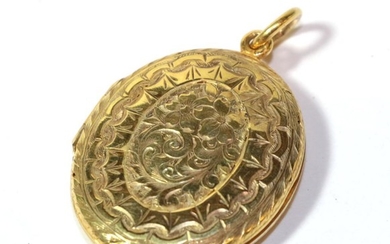 A foliate engraved locket, unmarked, length 4cm