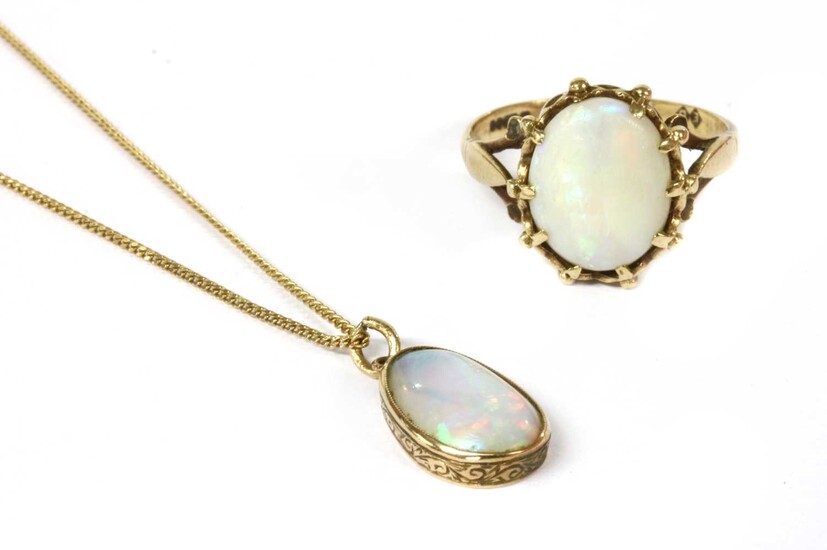 A gold single stone opal pendant