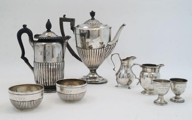 A group of silver, comprising: two Victorian circular bowls, London, 1883, S Smith & Son, with engraved monograms above gadrooned bases, engraved makers marks to underside, 8.2cm dia.; a Victorian hot water pot, London, 1884, makers mark rubbed...