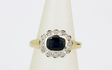 A hallmarked 9ct yellow gold ring set with a cushion cut 'teal' sapphire surrounded by diamonds, (M).