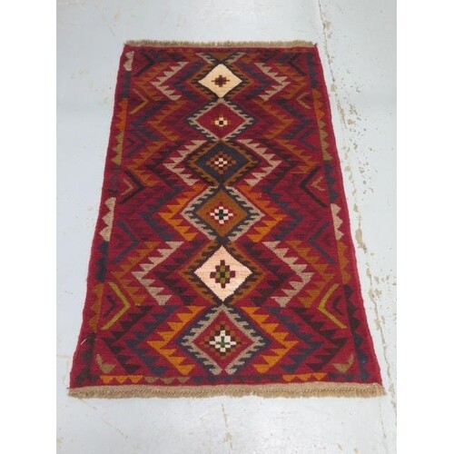 A hand knotted woollen new Baluchi rug, 136cm x 84cm
