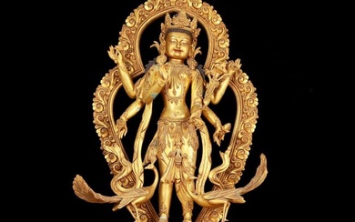 A huge gilt bronze statue of Manjushri with six arms