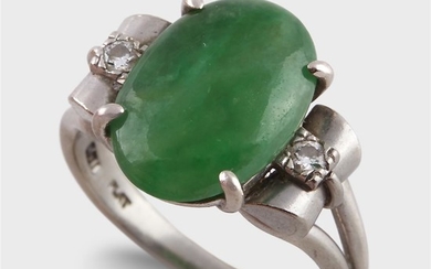 A jade, diamond, and platinum ring centering an oval...