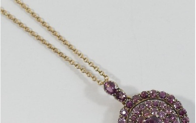 A late Victorian almandine garnet circular cluster pendant, ...