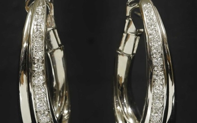 A pair of Continental white gold diamond set elongated half hoop earrings