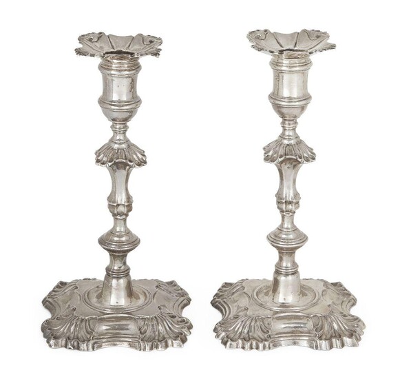A pair of George II cast silver candlesticks, London, 1751, William Gould, the knopped stems to shaped square bases with shell decoration to corners, the detachable sconces with conforming decoration (unmarked), 20cm high, total weight approx. 23.2oz