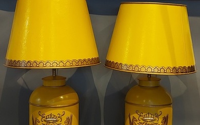 A pair of Toleware table lamps, each decorated with a crest ...