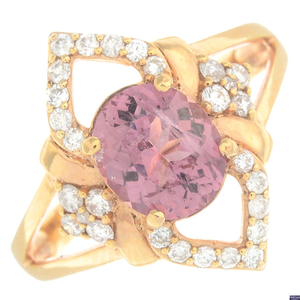 A pinkish-red spinel and diamond dress ring.Spinel
