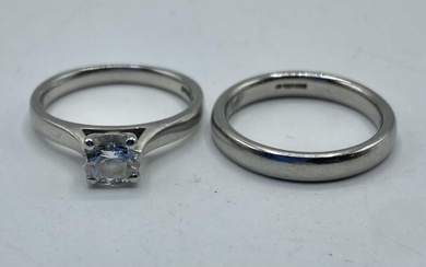 A platinum and single stone diamond ring together with...