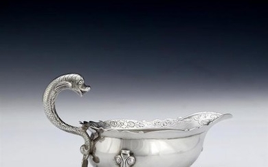 A scarce George II Scottish silver dolphin handled sauce boat by William Davie