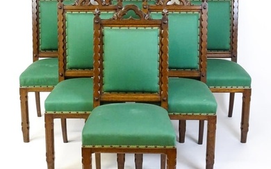 A set of six 19thC Gothic oak dining chairs , the upright supports having trefoil capitals flanking