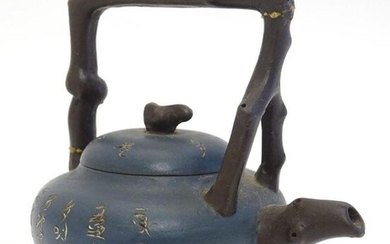 A small Chinese Yixing earthenware / clay teapot and