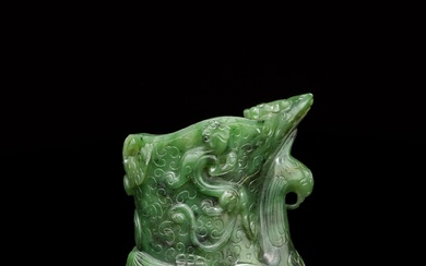 A spinach-green jade archaistic 'phoenix' rhyton, Qing dynasty, 18th century | 清十八世紀 碧玉雕仿古祥鳳螭龍觥