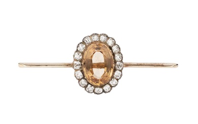 A topaz and diamond mounted bar brooch, the oval orange-brown...