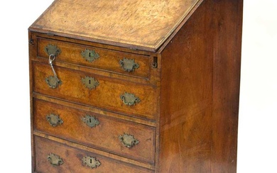 A walnut and feather banded bureau of small proportions, the...