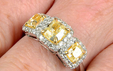 A 'yellow' diamond and diamond three-stone cluster ring.