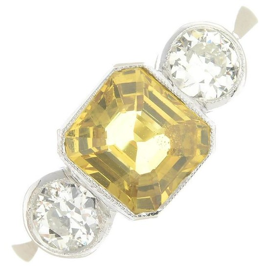 A yellow sapphire and diamond three-stone ring.Sapphire
