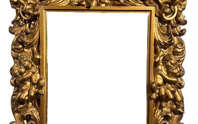 AN 18TH CENTURY ITALIAN FLORENTINE CARVED GILTWOOD MIRROR Decorated...