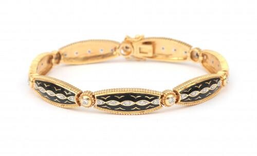 An 18 karat gold enamel and diamond bracelet. Composed of navette shaped links featuring black enamel. Set with brilliant cut diamonds, in total ca. 0.63 ct. Gross weight: 25 g.